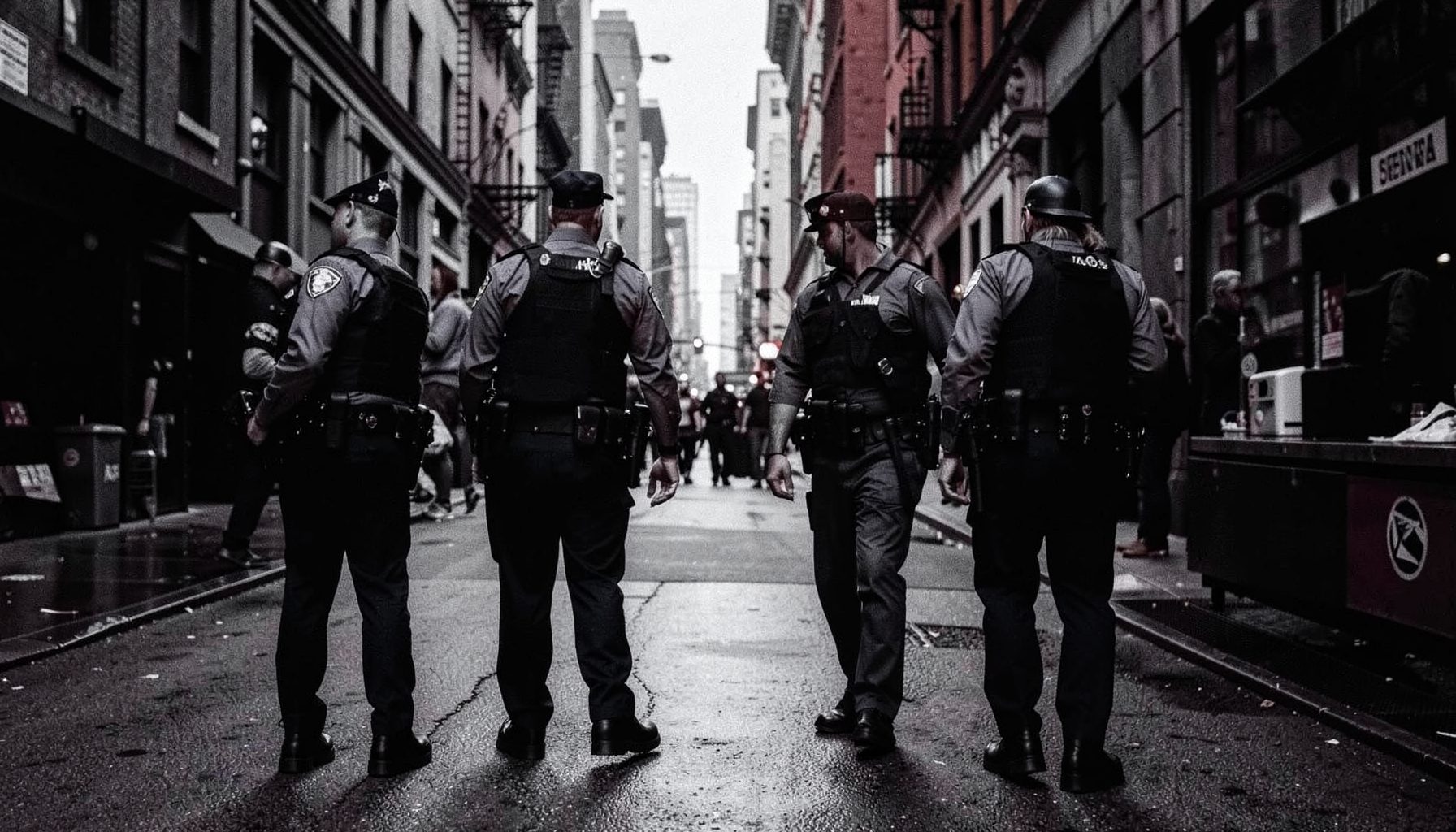Police officers on city streets with navy blue and steel gray tones, gritty mood
